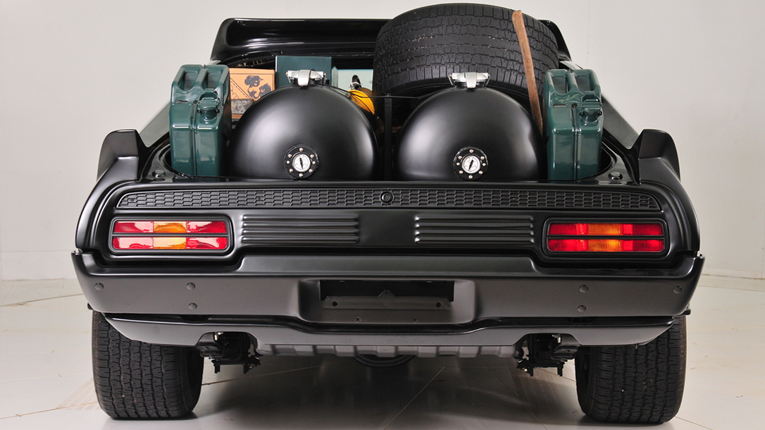 It had had a full trunk and rear window (for you purists, that’s “boot” and “backlight”), which they removed for more of a survival elan, with two enormous cylindrical fuel tanks, a spare wheel and the like.