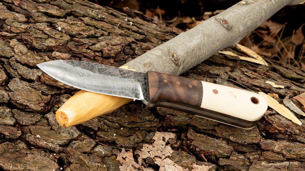 Sharpen the tip, but not to a point. You will need the extra stock to ensure the barbs come out right.