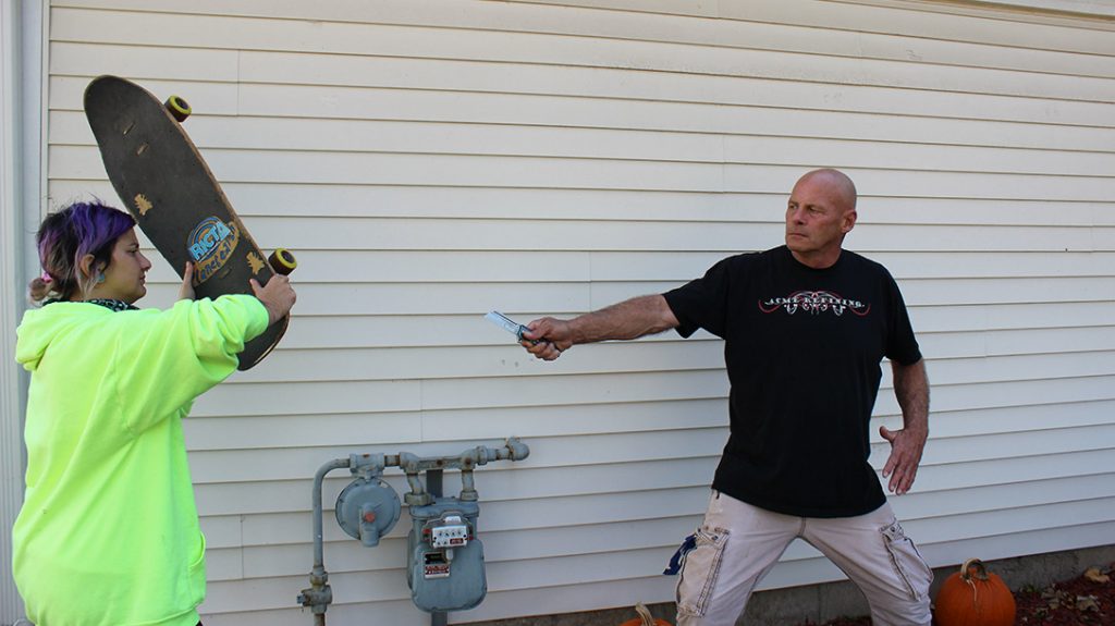 Use anything that you can as a shield and weapon for knife defense.