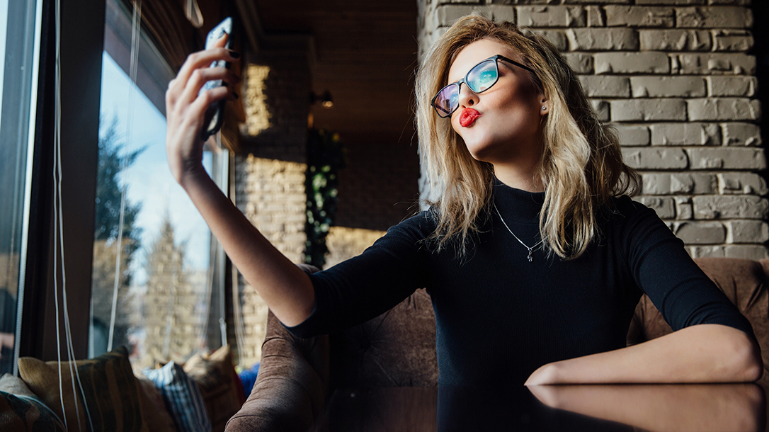 A pretty narcissist checking herself out on her phone!