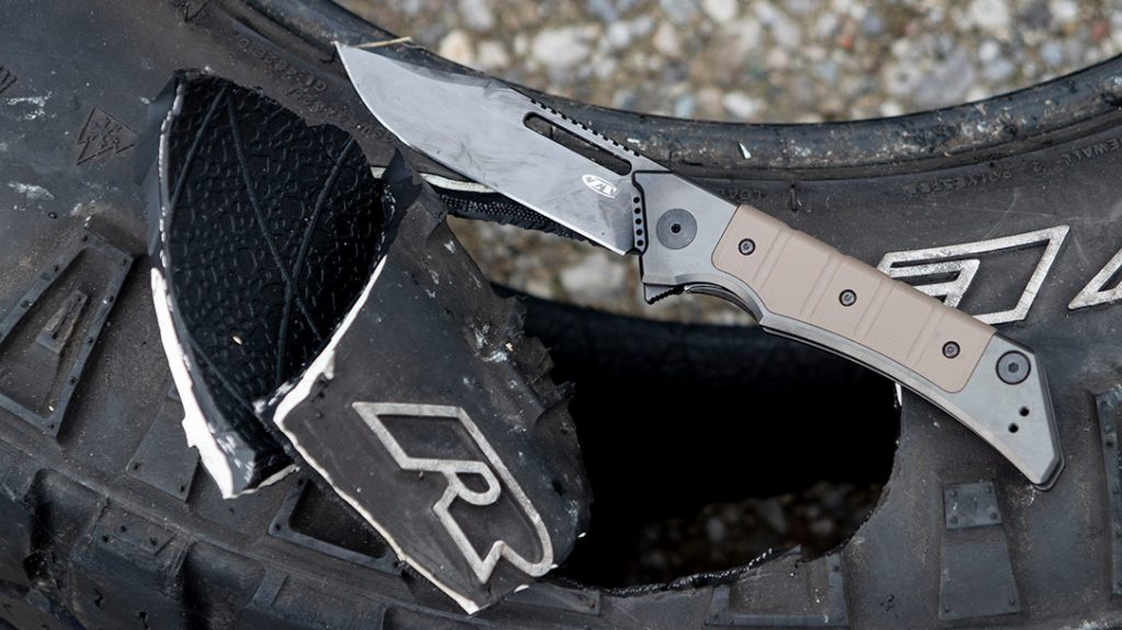 The clip point of the 0223 easily penetrated the sidewall of this radial truck tire. The edge made short work of slicing out a chunk and bisecting it—without damage or wear to the edge.