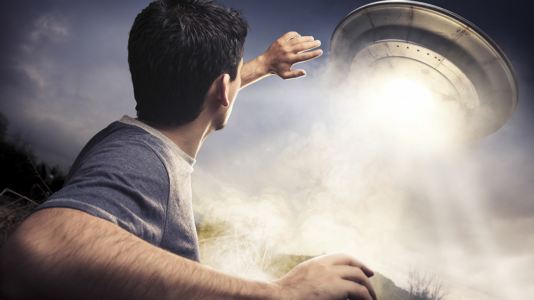 Man about to be abducted by an alien.