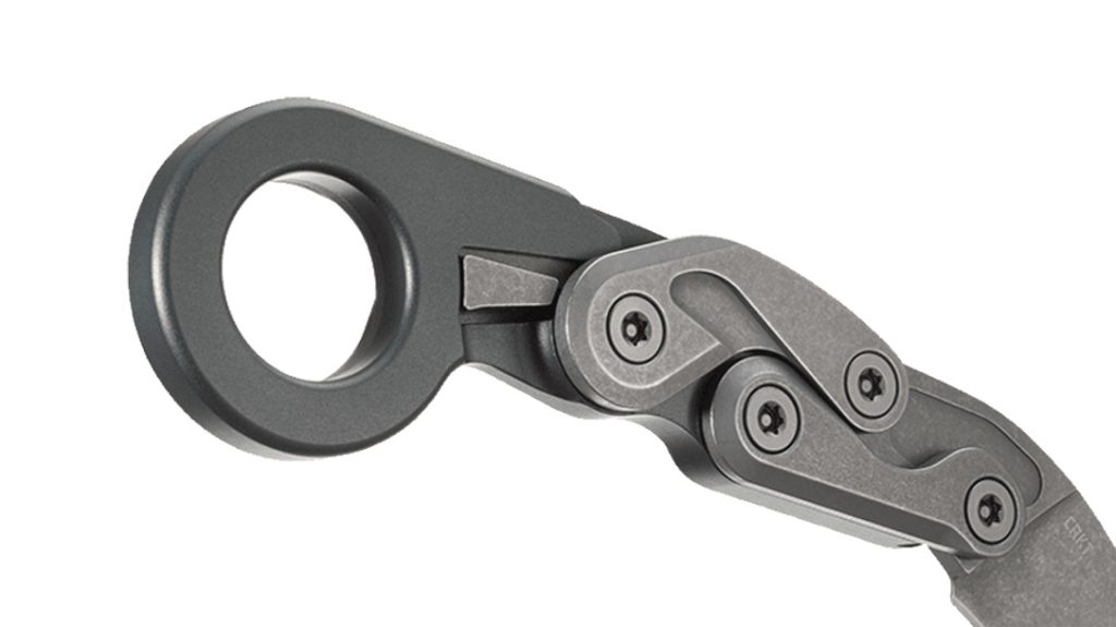 The sliding lock mechanism sits just forward of the ring and requires two hands to disengage.