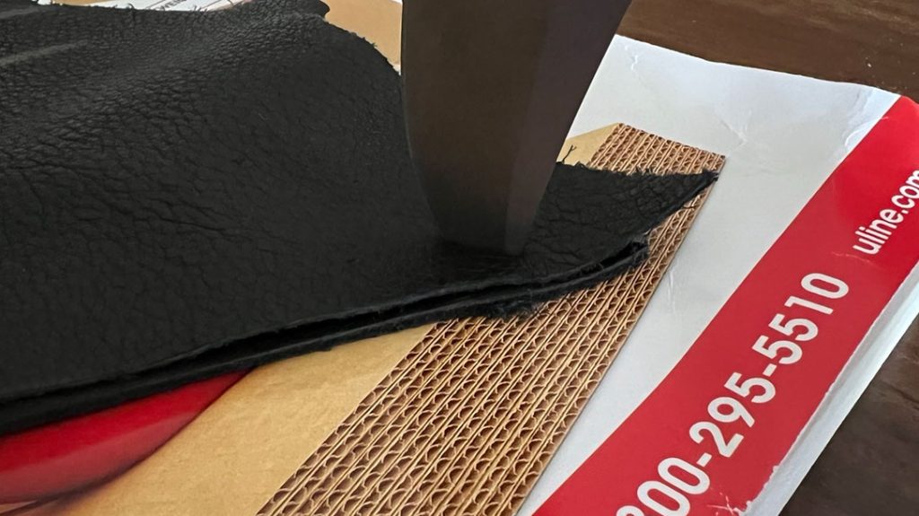 The tip penetrated easily through two thick pieces of leather and into a catalog.