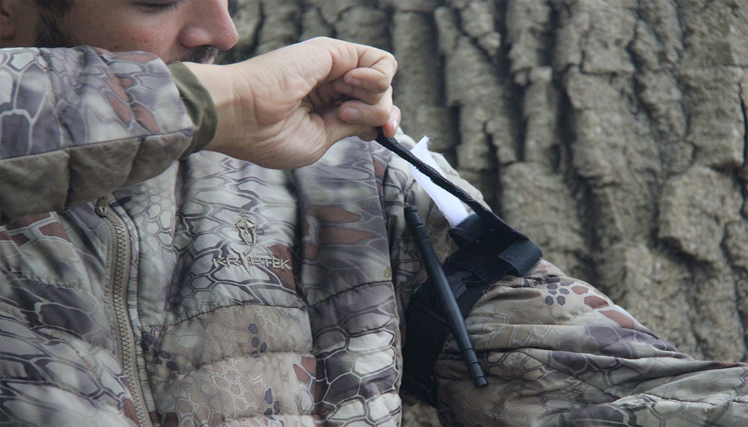 Properly applying a tourniquet on your arm.