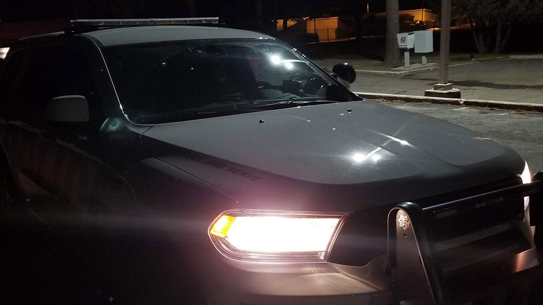 My patrol car sitting out front of the crime scene of an active investigation.