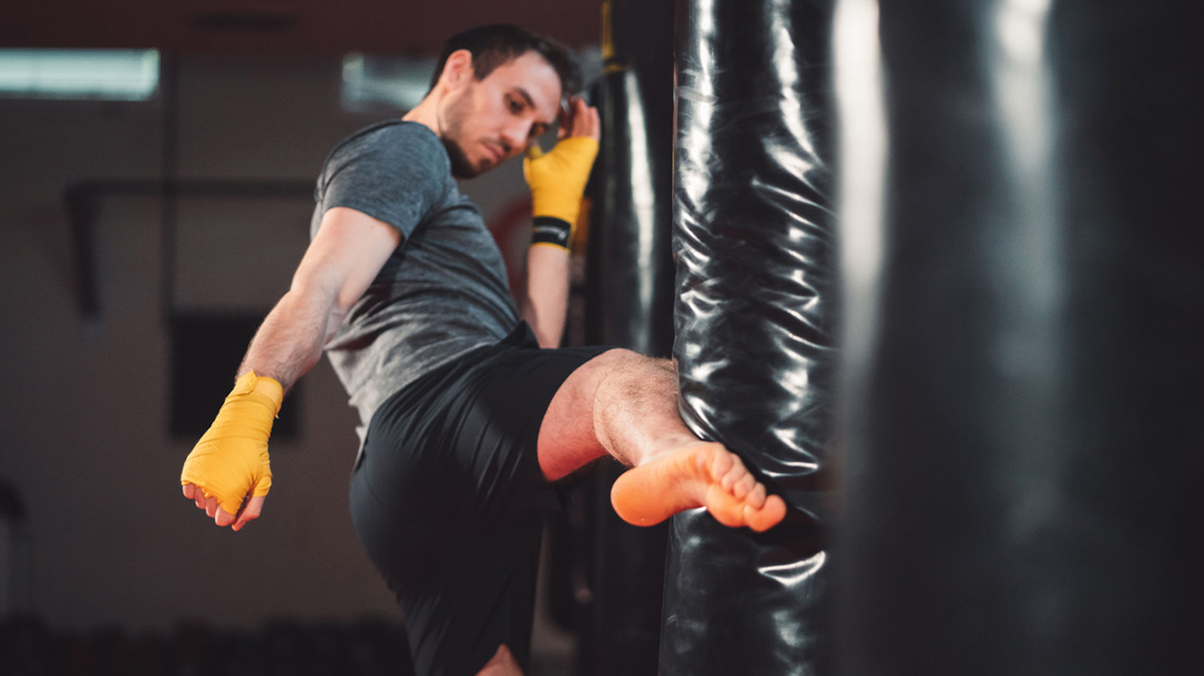 Do you know how to deploy a front kick in a survival situation to fight off attackers?