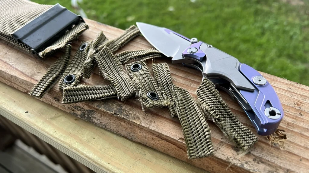 The Rike Knife Alkaid cleanly cut through a heavy-duty nylon military gun belt.