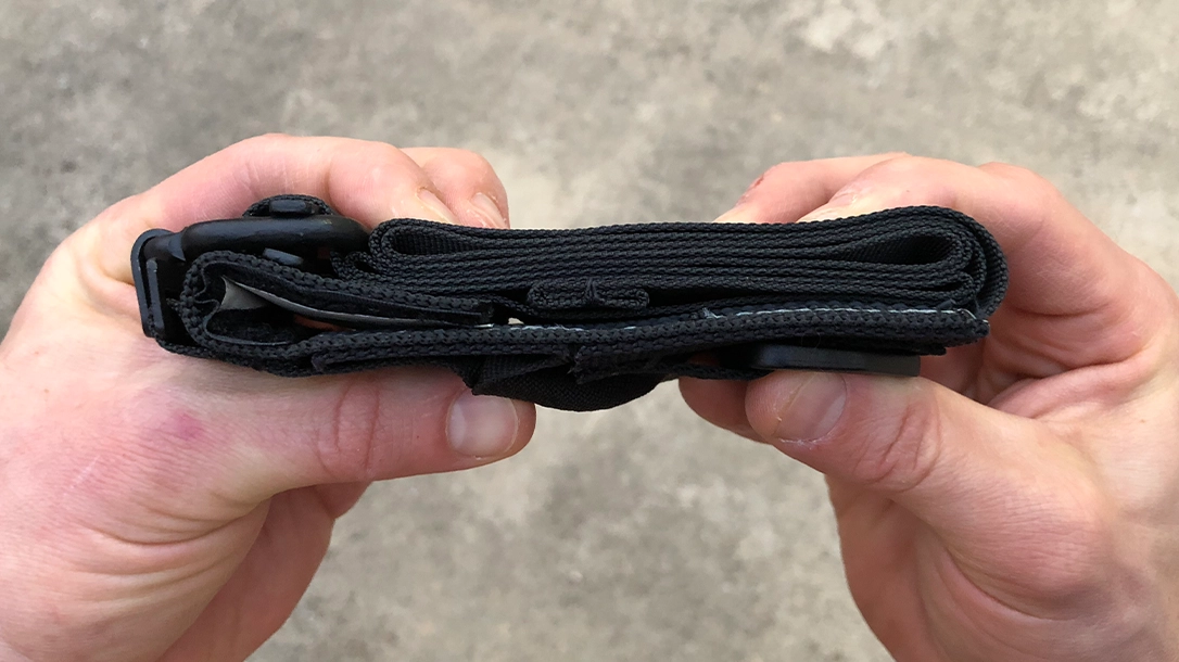 Fold up the excess strap on a tourniquet.