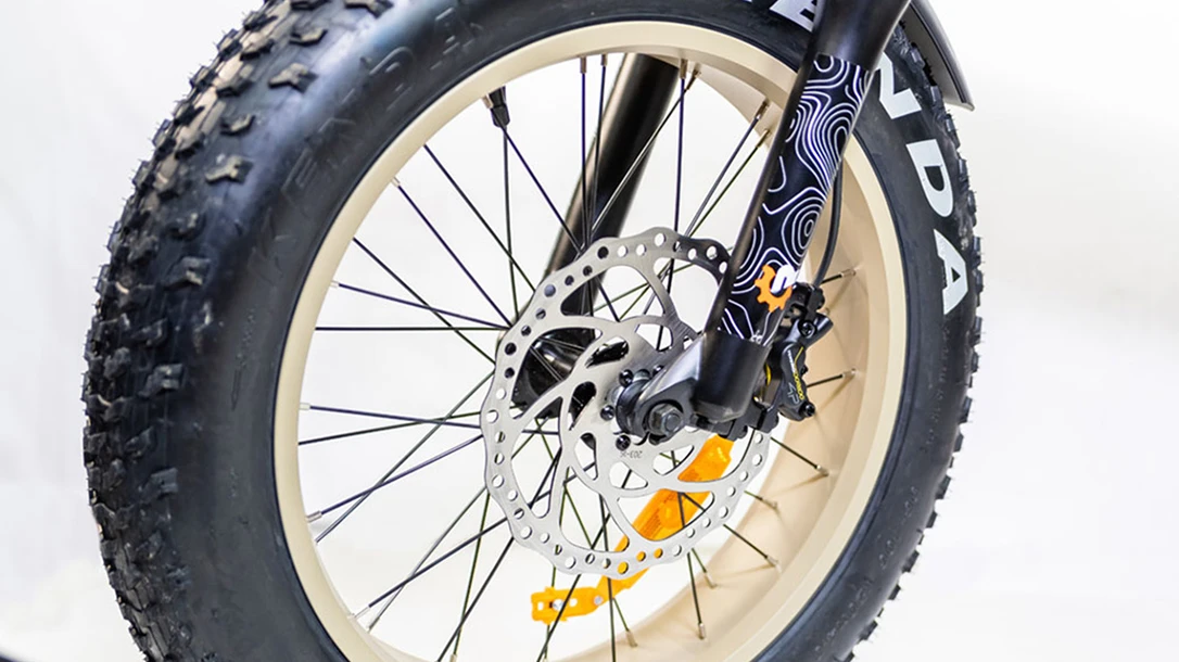 The electric off road bike comes equipped with large tires and disc brakes.