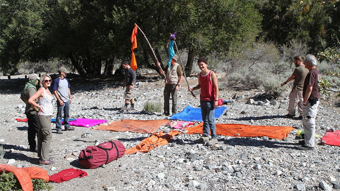 During a survival class at Randall’s Adventure & Training, students set up signals using their vibrant gear to create contrast.