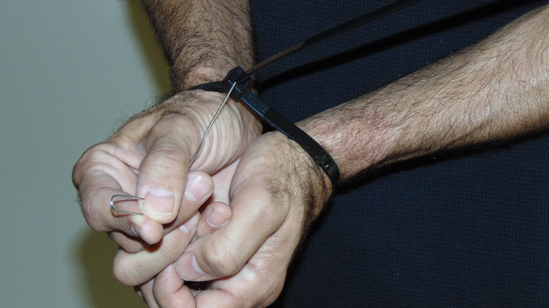A simple paper clip can be used to unlatch most zip ties and allow you a fast escape.