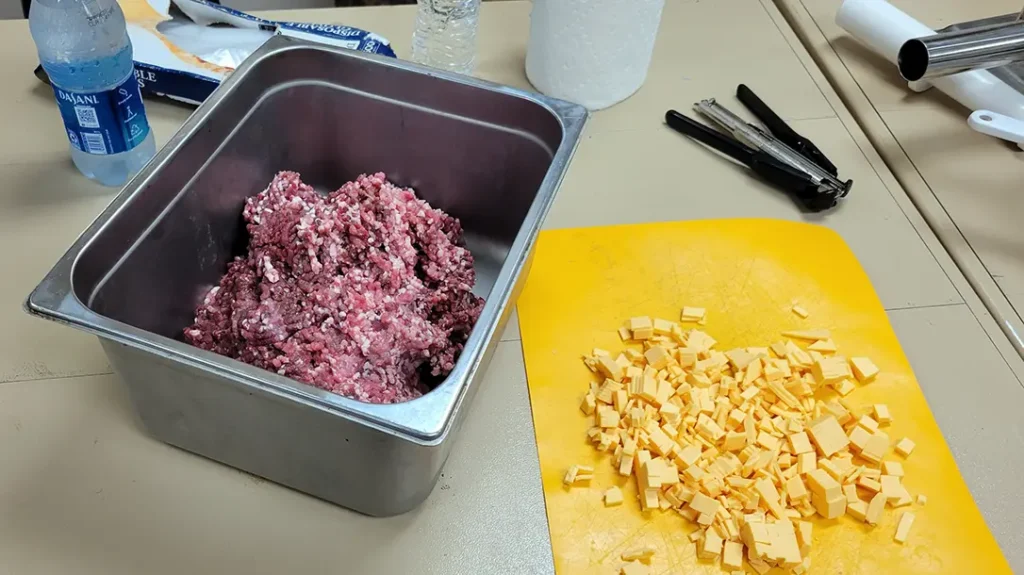 Preparing the meat with cheese.