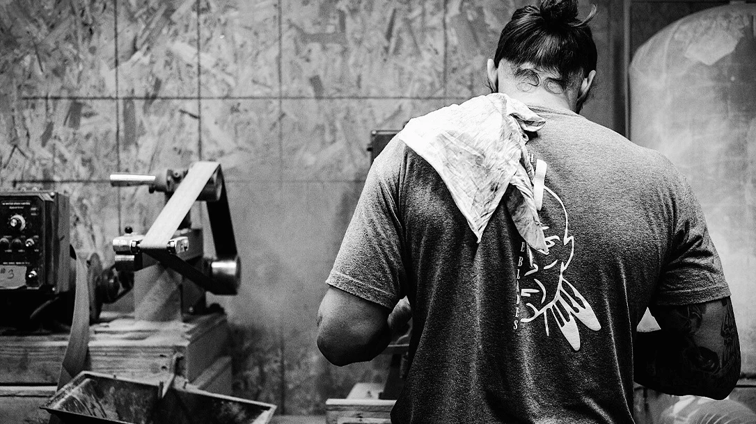 Andy making a blade in his shop.