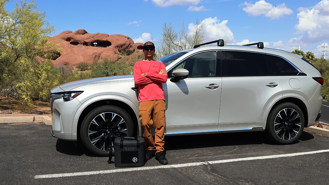 Skillset editor, Ben Tirpak stand next to the 2025 Mazda cx-90.