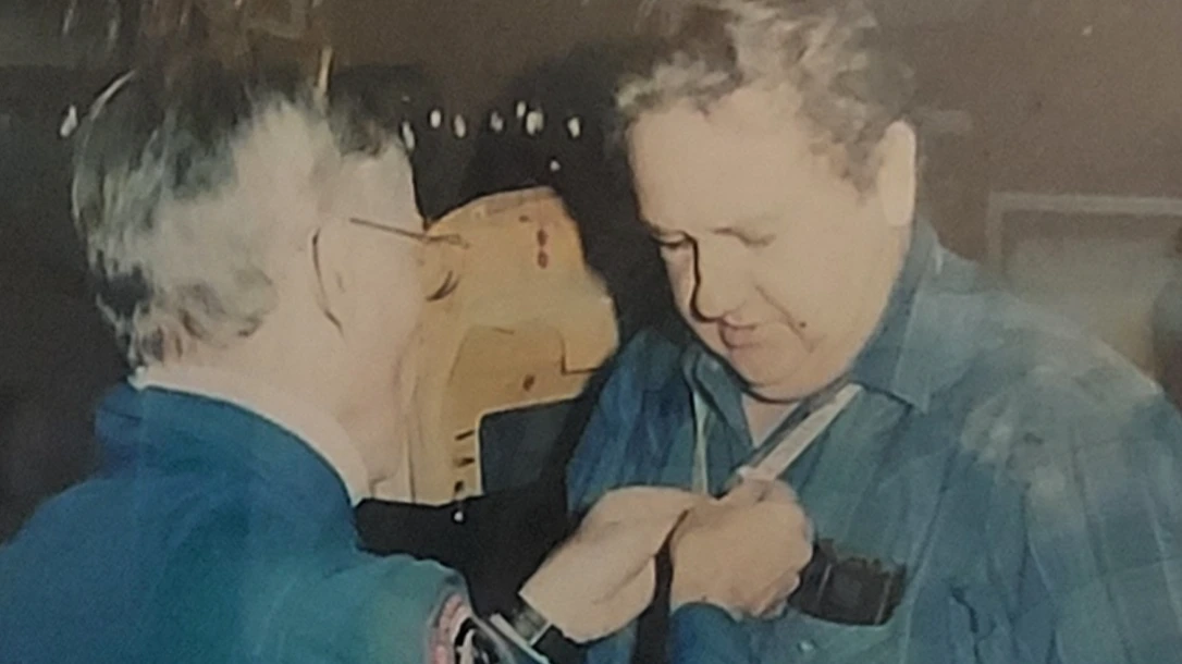 Astronaut, John Young, presenting Lead Man of the Components Test Facility, Gary Sparks with the Silver Snoopy.