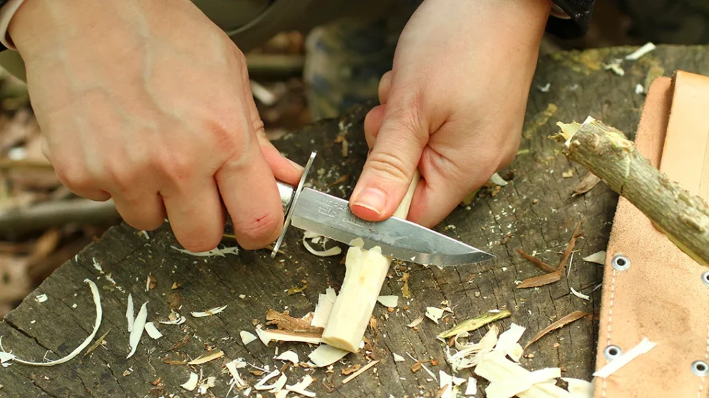 Knife Safety for Kids: When carving, the author prefers using a thumb-assisted push-cut grip, also known as a scissor cut.