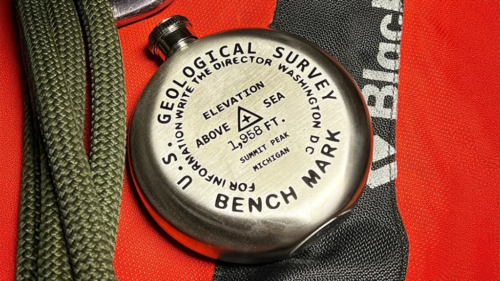CORVUS Tool & Knife offers an engraved to-order Benchmark Flask with your choice of location and elevation. Comes with a funnel to fill the 5-ounce brushed stainless steel flask.