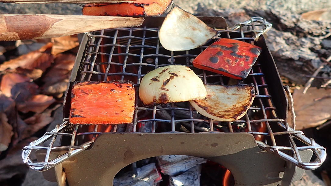 The author cooked peppers and onions atop the New Era Überleben Stöker Stove. Cooking over coals is the way to go.