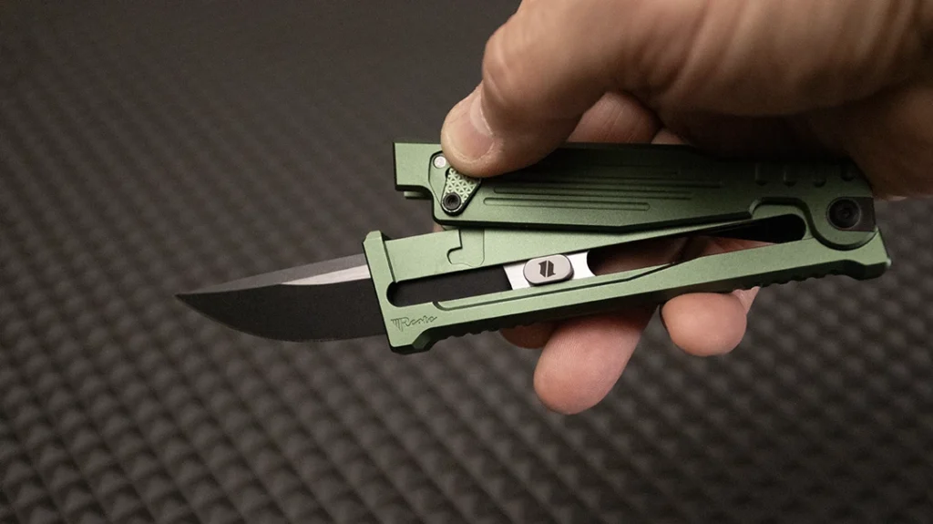 Next, point the knife down to allow the blade to slide forward.