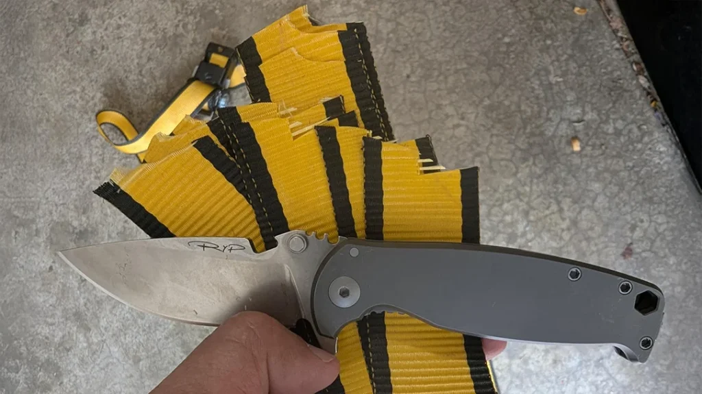 The author repeatedly folded the ratchet strap so that it would have ten layers that the DPx Gear HEST/F 4.0 Ti would have to cut through with a single swipe.