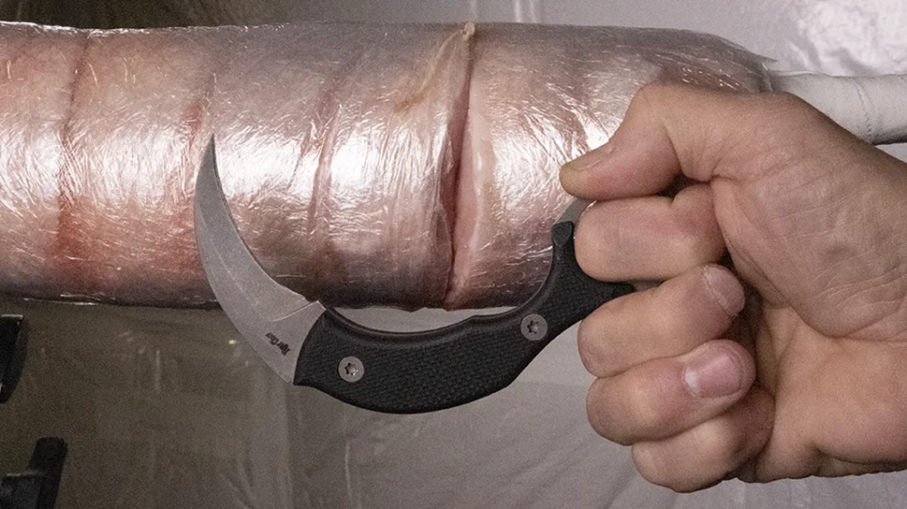A pulling cut using a well-designed karambit with a deeply curved blade and a “brake” cut almost two inches deep into Pork Man.