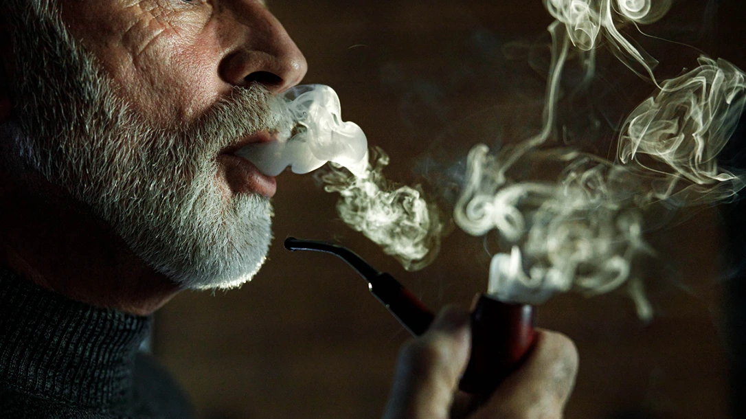 Examine the cultural significance of pipe smoking as a meditative ritual that fosters connection and conversation across generations.