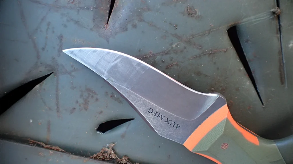 Hammered in an ammo canister, the blade and handle scales shrugged off a whack from a hardwood baton.