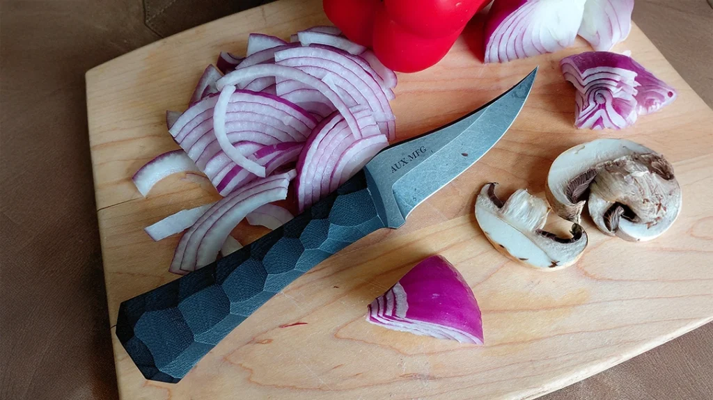 Showing its moves, the Auxiliary Manufacturing Pocket Bowie XL Knife can hack the heat of the kitchen.