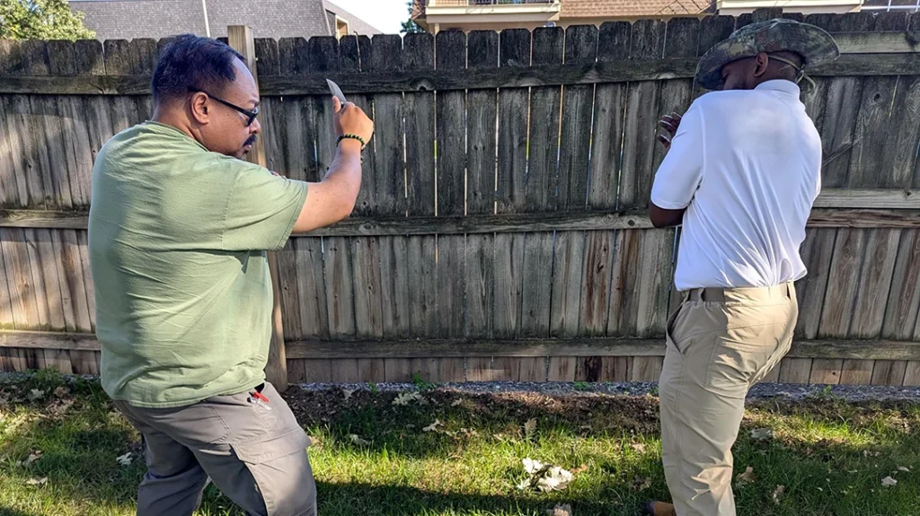 Cass reels back, holding his arm, and Frank remains ready to continue the fight.