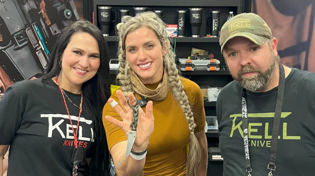 Melissa Miller proudly displays her T.Kell Knives WharnEDC design, flanked by Tim and Suzanne Kell.