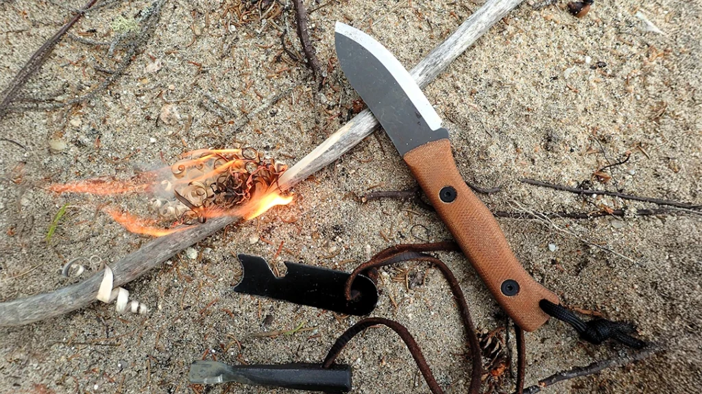 Nessmuk Trio: The author carved a rough feather stick with the KBK Cub-Muck and used the sharp 90-degree spine to scrape the ferro rod.