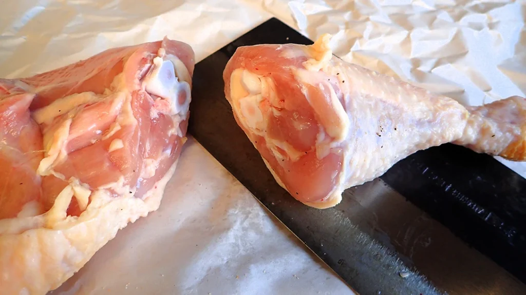 The Chinese Veggie cleaver easily slices through the leg joint without any chopping.