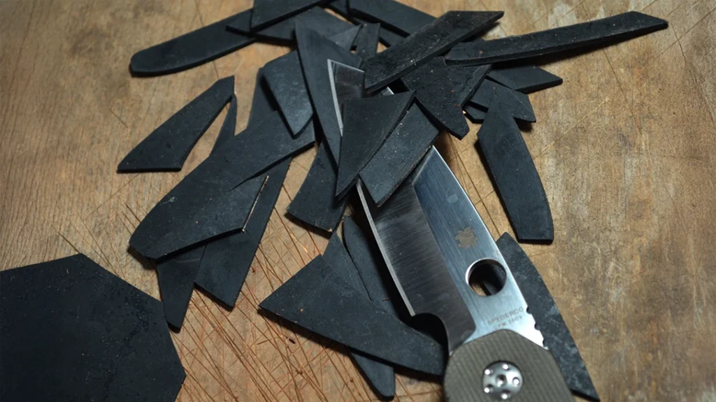 The Spyderco Smock’s blade point made short work of this sheet of rubber.