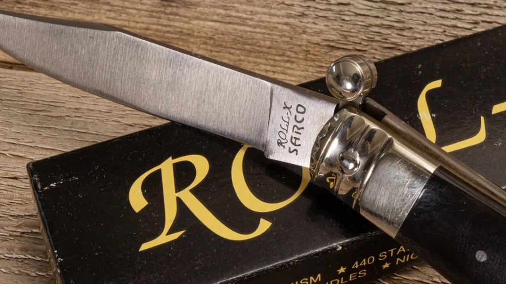 History of Thumb Openers: A close-up look at the thumb opener of the Roll-X pushed forward to release the knife’s back-lock mechanism.