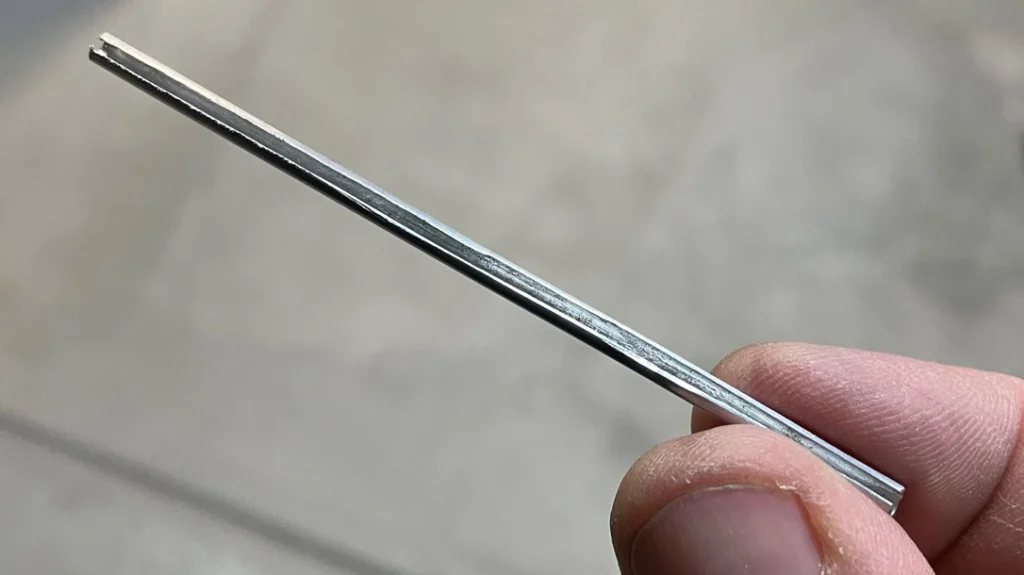 Making a Training Knife: Working carefully, the author cut a slit in one side of the tubing about an inch longer than the blade.