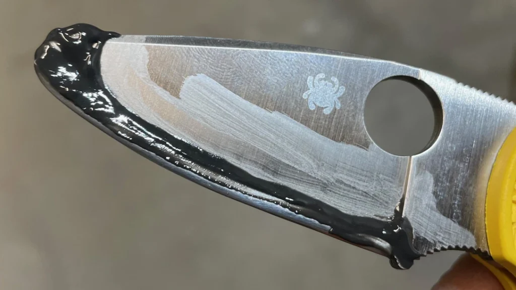 Making a Training Knife: The author then mixed up some JB Weld steel-reinforced epoxy, applied it to the blade edge, and slipped the tubing in place.