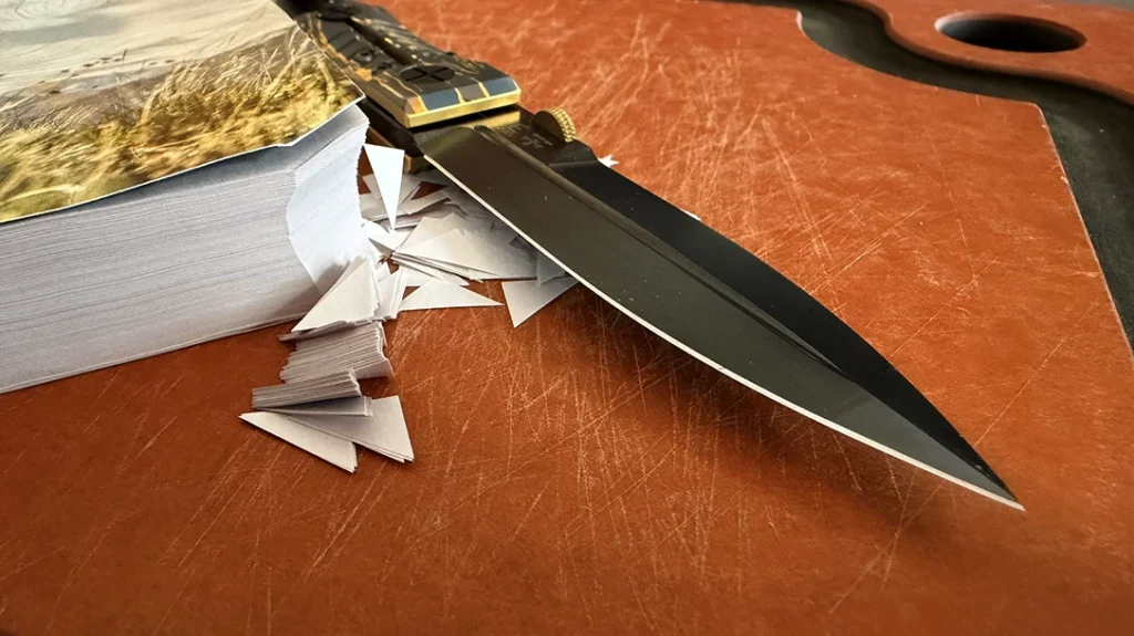 The keen edge on the Elishewitz Les George Ek Integral Folding Knife pressed right through the entire corner of this catalog.
