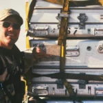 Morgan stands posed next to the gear.