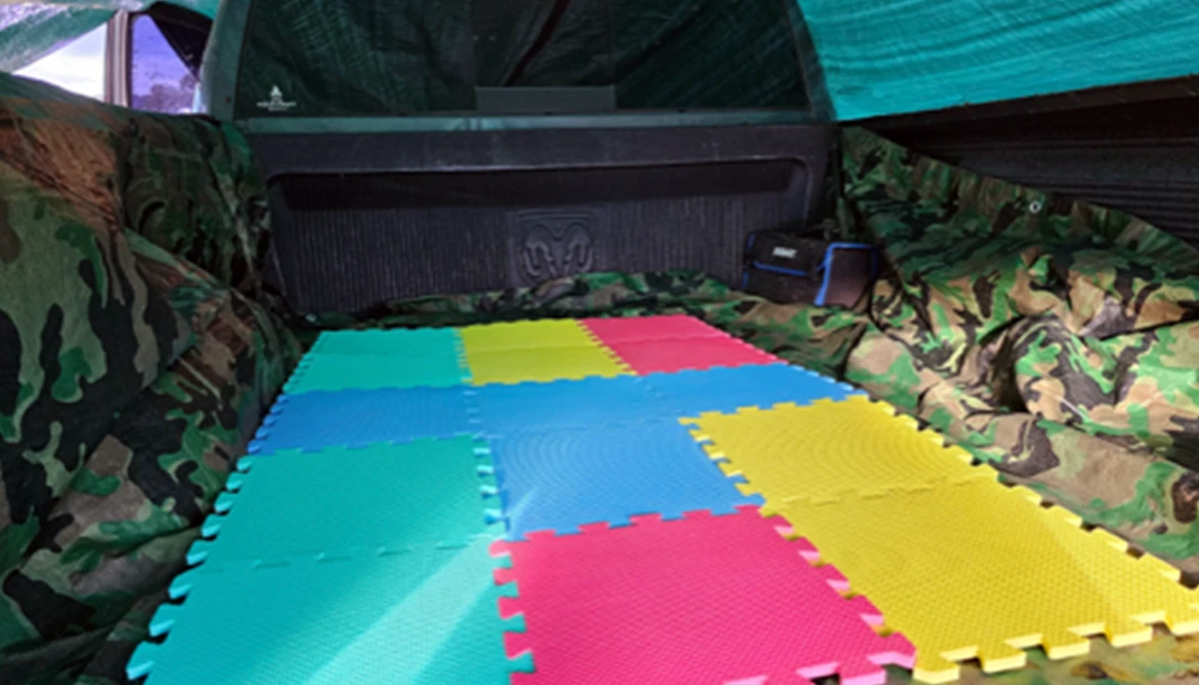 Rear view of the truck-bed tarp shelter that got me through a cold and windy night.