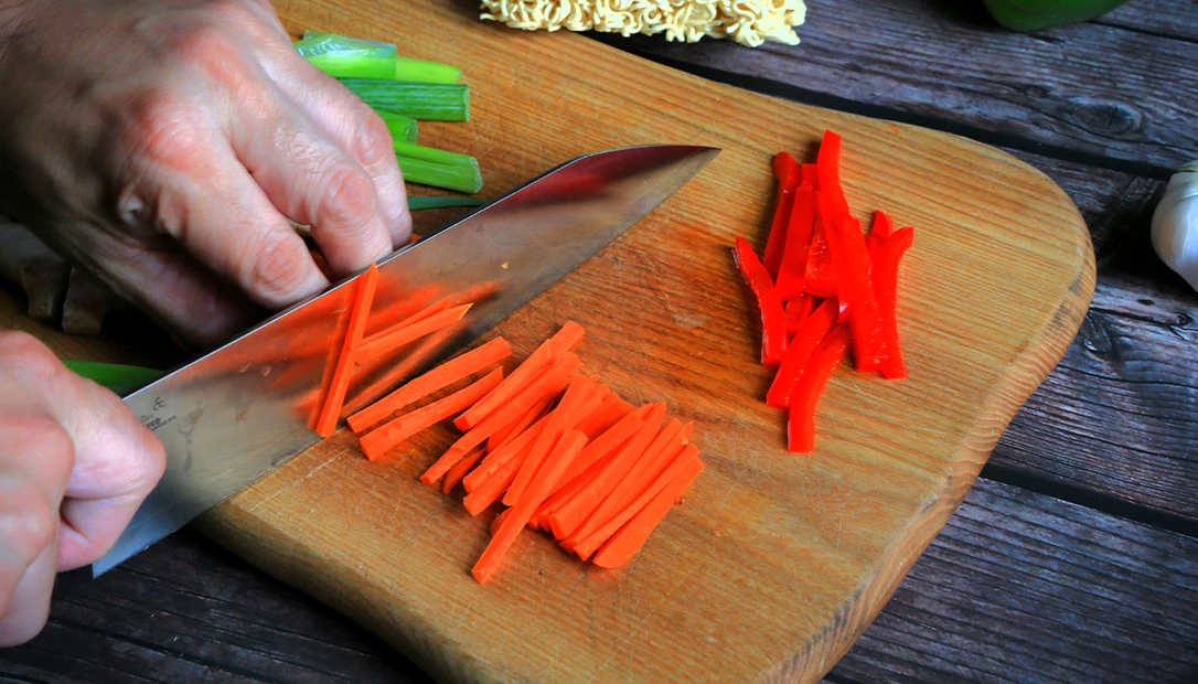 Close-up of proper knife grip technique for safe and precise cutting.