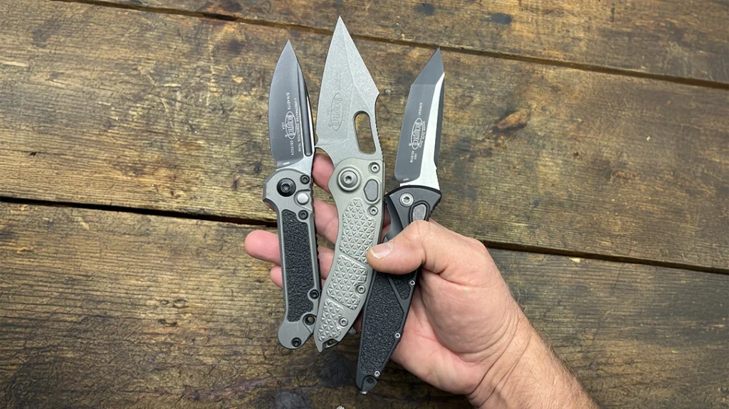 Sense of scale of the various auto folders by being placed in the hand. Left to right are the L.U.D.T., Stitch, and SOCOM Elite.
