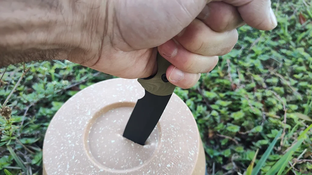 The Toor Knives TKOR-4.5 SERE’s puncturing power was tested using high-density plastic.