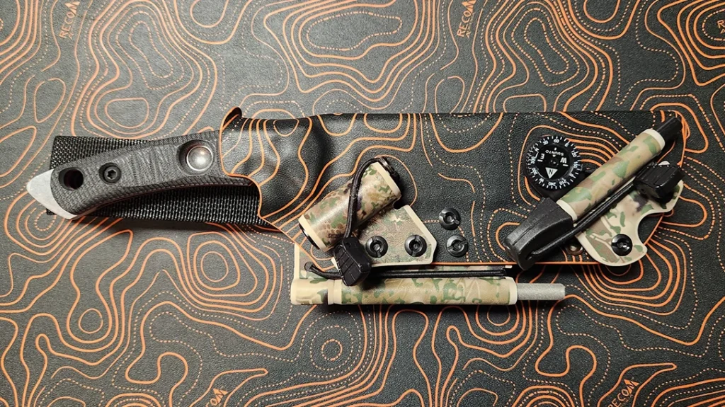This custom sheath from Yellow Hawk Custom Kydex for a Fobus Tier 1-BC demonstrates both custom Kydex topographic print and multiple accessories creating a carry system for survival kit items.