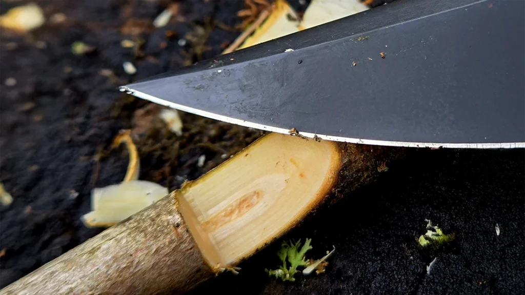 The belly of the blade worked well for fine carving like this 90-degree latch used in trap making.