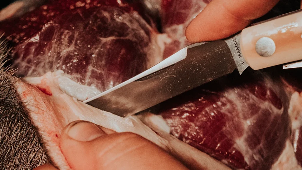 The trapper made quick work of skinning the wildebeest.