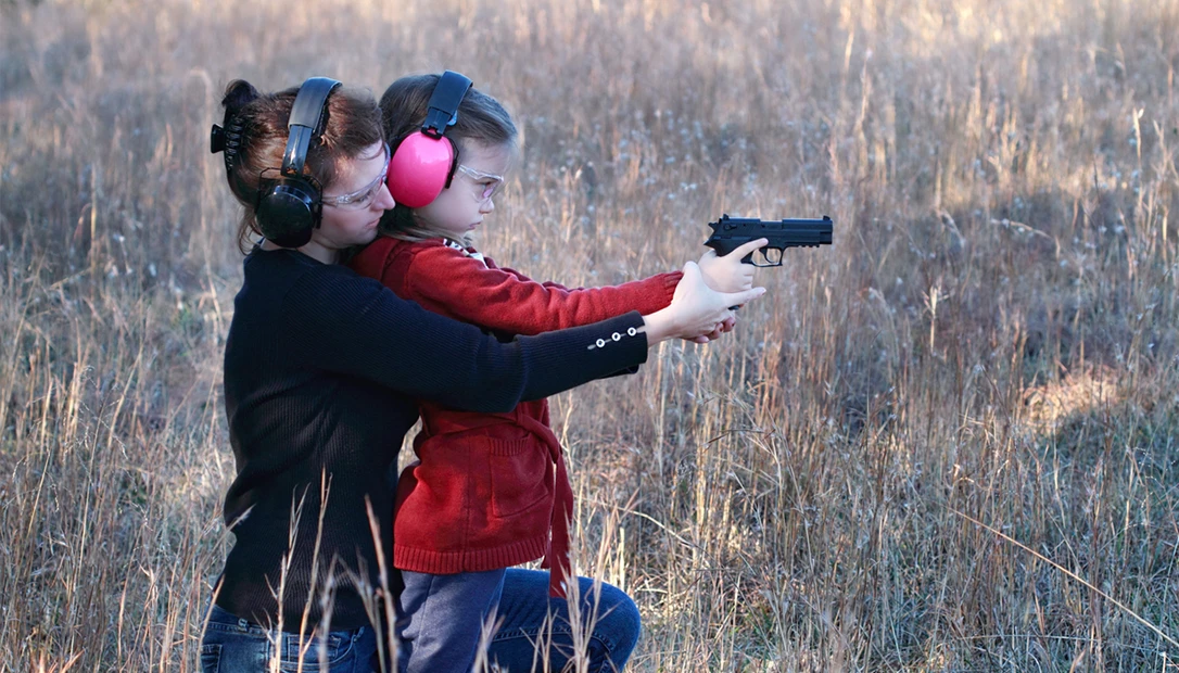 Protective mother teaching preparedness and safety skills to her children outdoors.