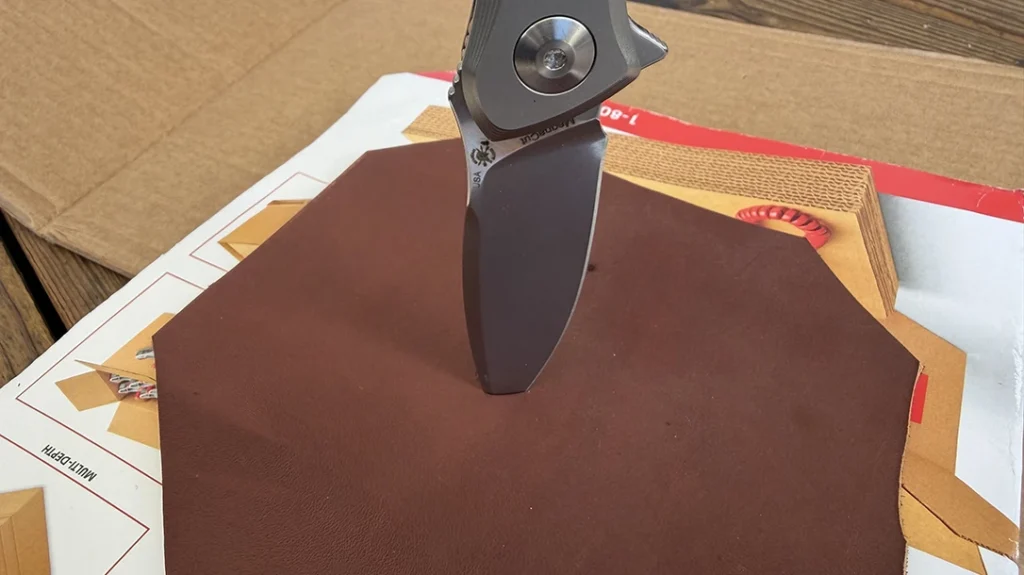 The tip penetrated the leather and into the catalog, just over a quarter inch in total.