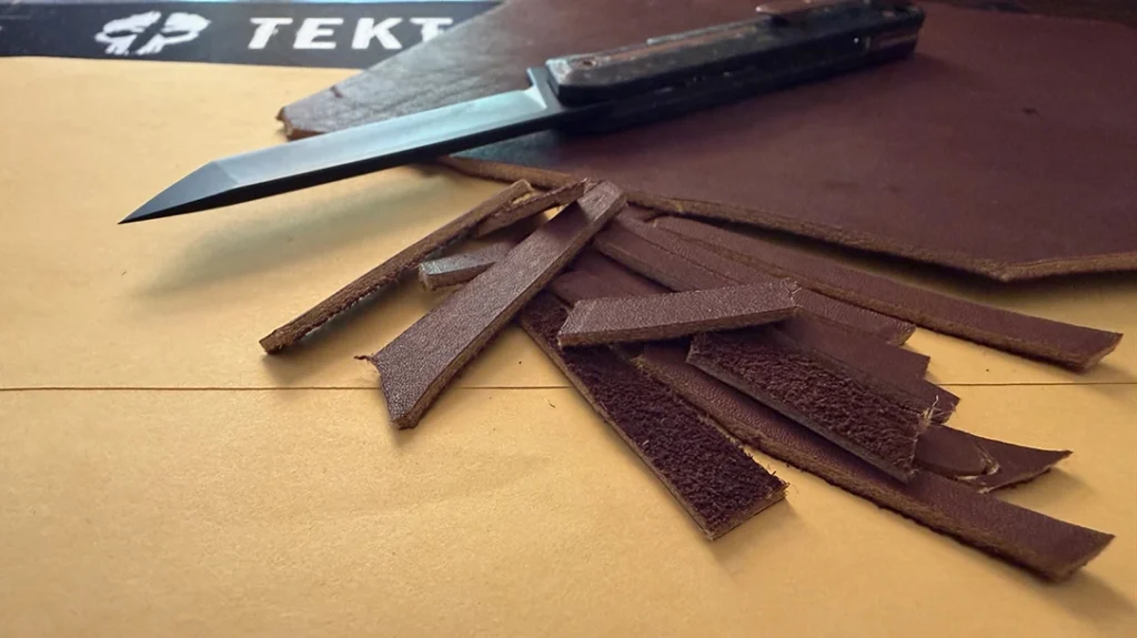 Like cutting paper, I sliced slivers off a piece of heavy-duty leather I use in a lot of reviews.